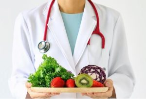 Food as Medicine (Doctor holding a plate of fruits and vegetables)