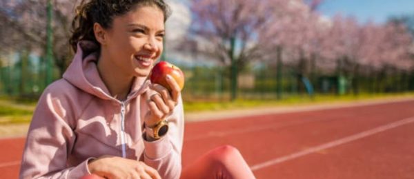 Female Athlete with Apple Image Female Athlete with Apple Image